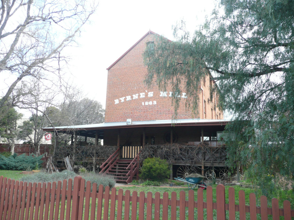 Byrnes Mill as seen in 2014 from Collett St – the only significant historical place associated a its Millhouse and potential public gathering space in central Queanbeyan. Restored in 1977 by me. Copy of these pages and other papers sent to Queanbeyan Historical Society 17 Aug. 2015